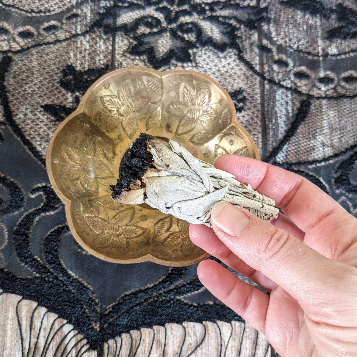 A burned sage bundle
